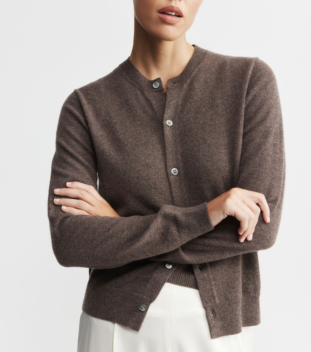 Brown cardigan worn by a person on a light gray background