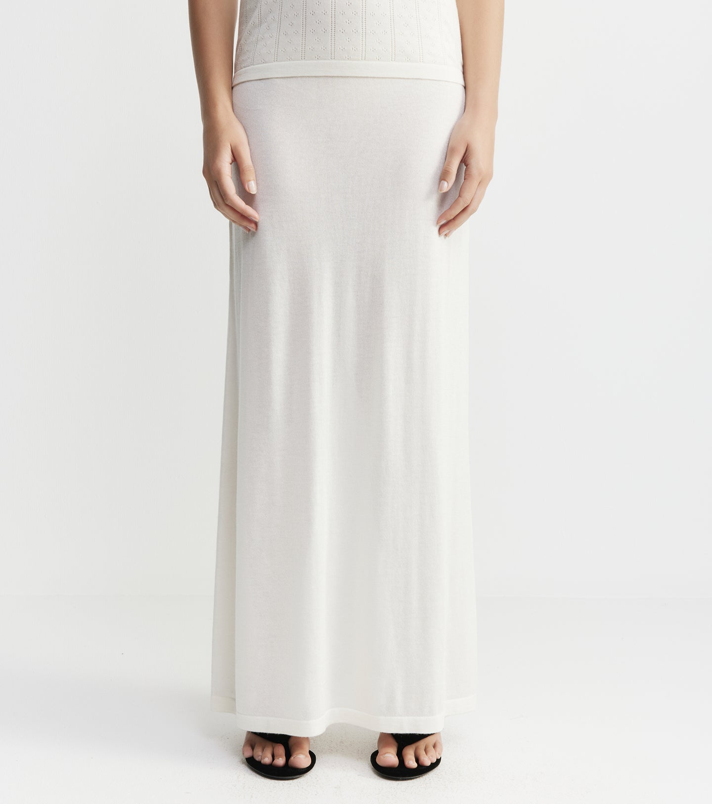 White wide-leg pants worn by a person on a white background