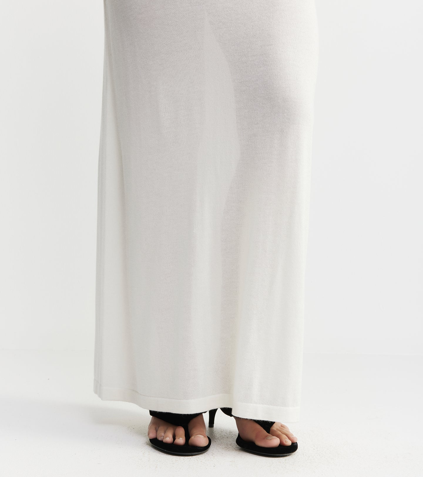 White pants with black sandals on a white background